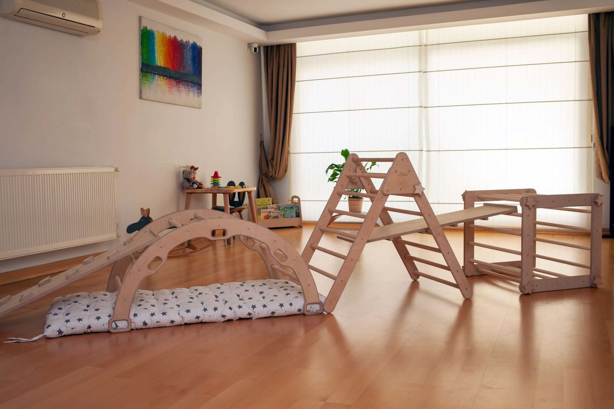 Wooden Montessori playset with climbing triangle, cube, arch, ramps, and cushion