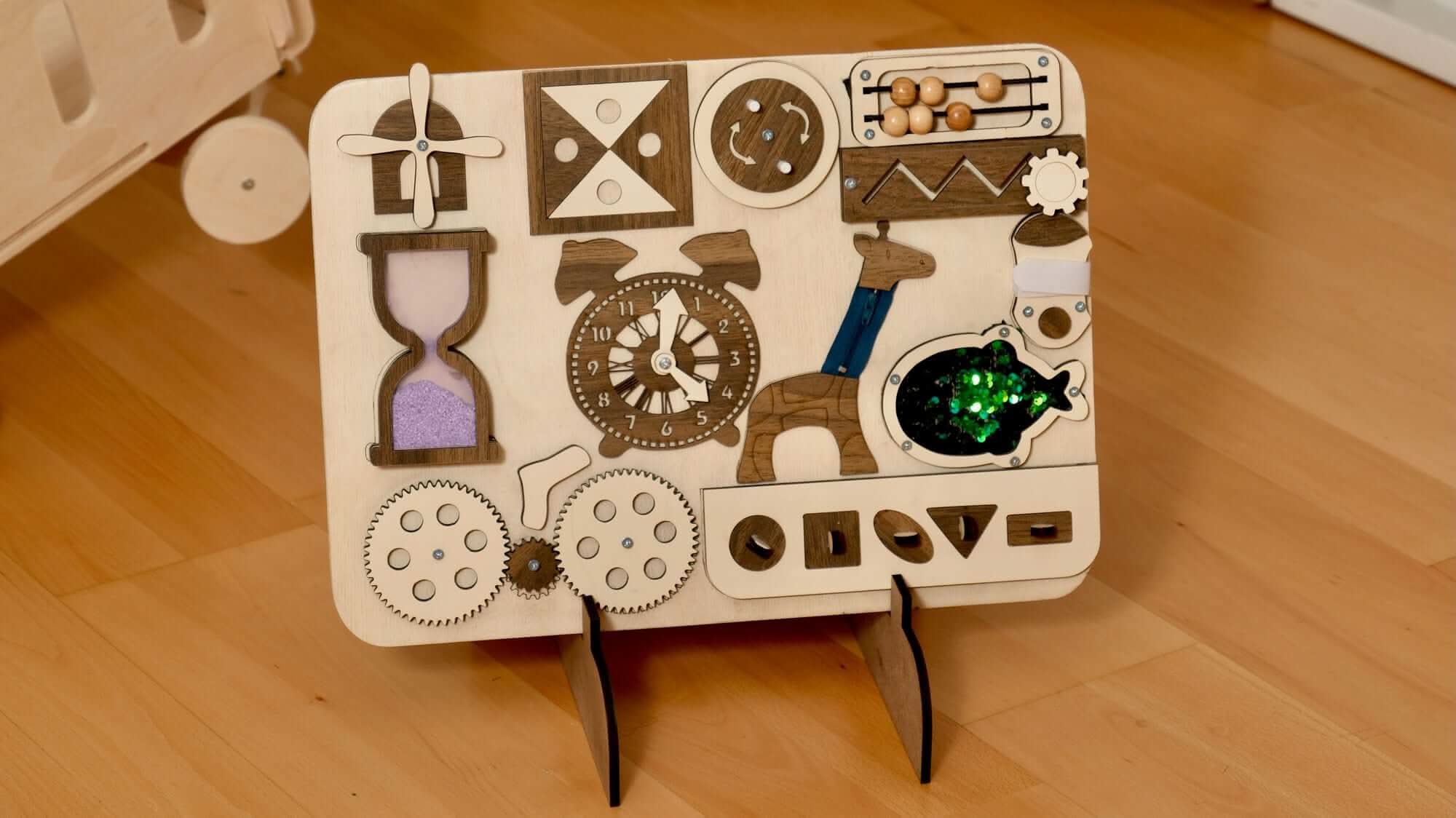 Wooden Busy Board for toddlers featuring gears, clock, abacus, and hourglass for hands-on learning.