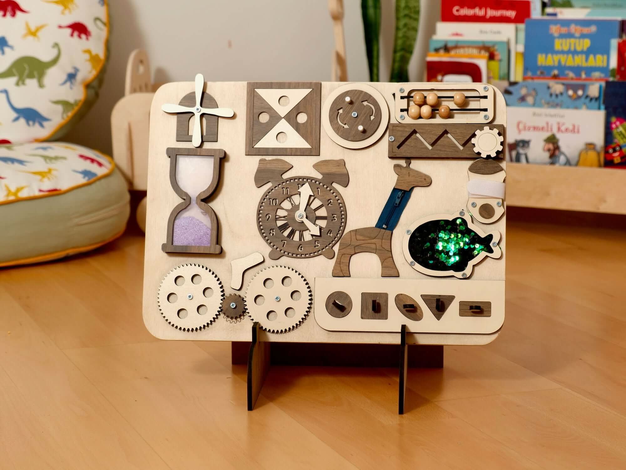 Wooden Busy Board for toddlers featuring gears, hourglass, clock, and sensory activities for hands-on learning.