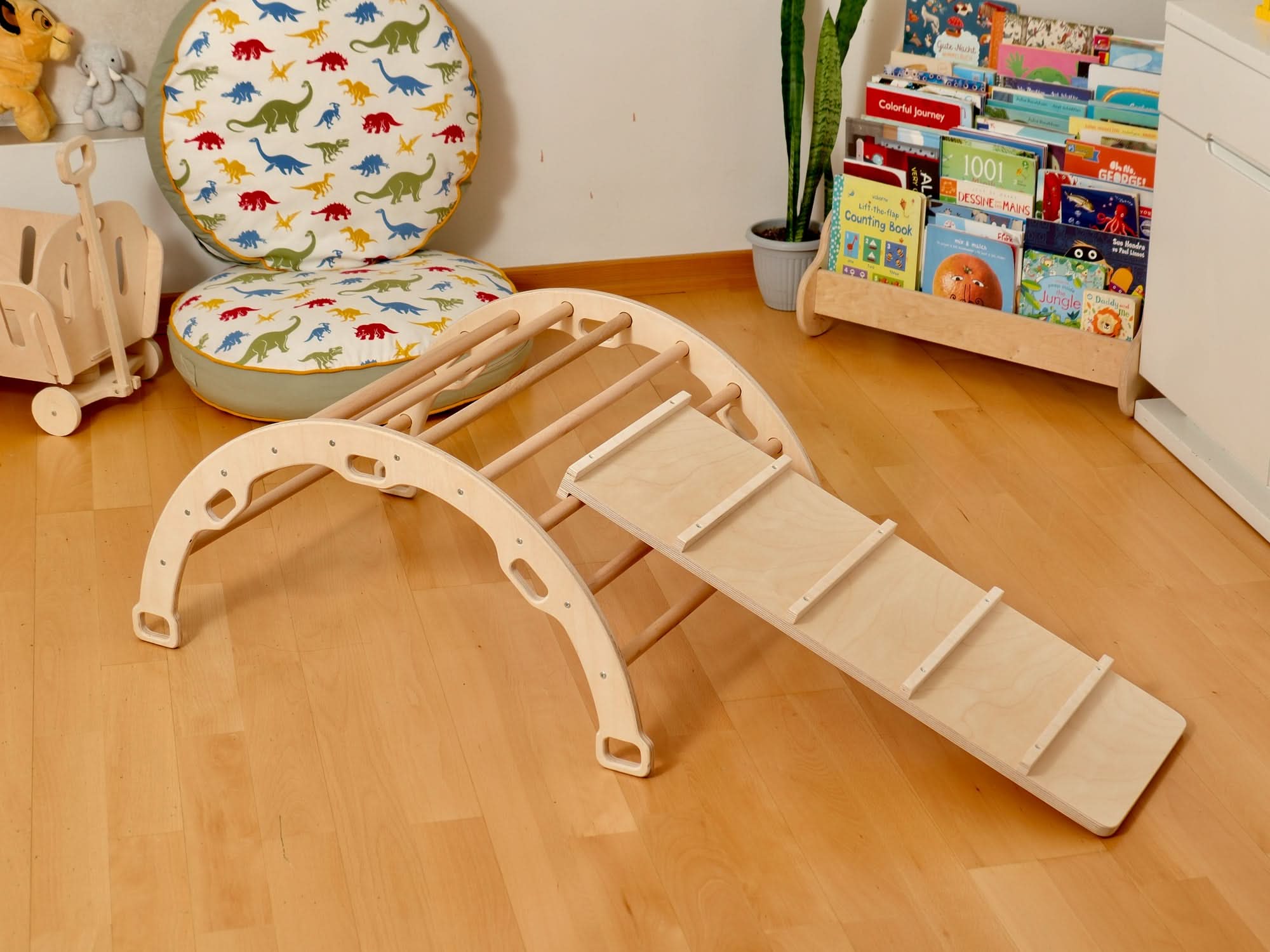 Montessori indoor playground climbing set featuring a Pikler triangle and climbing arch with a slide.