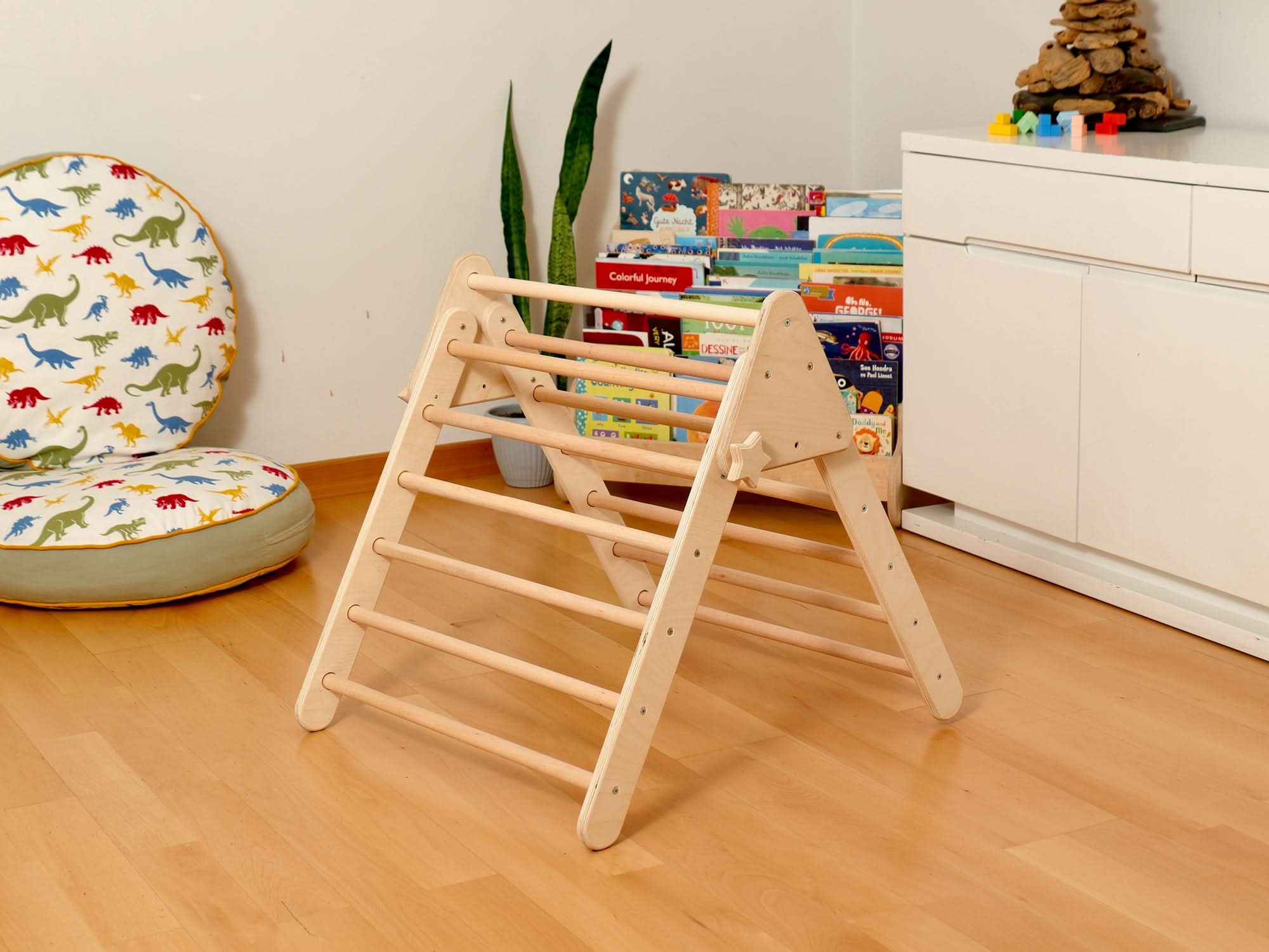 Montessori Pikler triangle for indoor playground with wooden climbing set, perfect for toddlers to enhance balance and play.