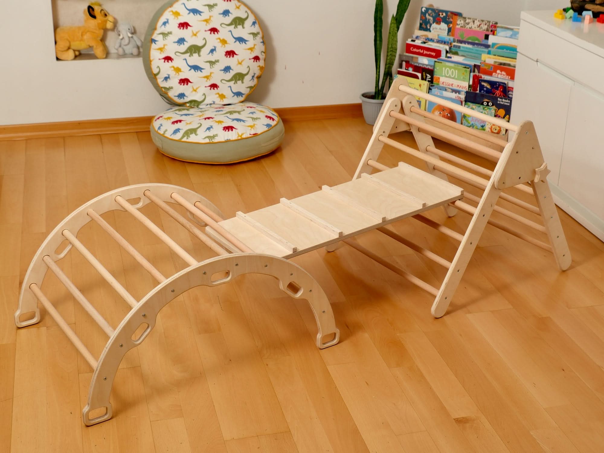 Montessori indoor playground with Pikler triangle and climbing arch for toddlers, enhancing play and balance.