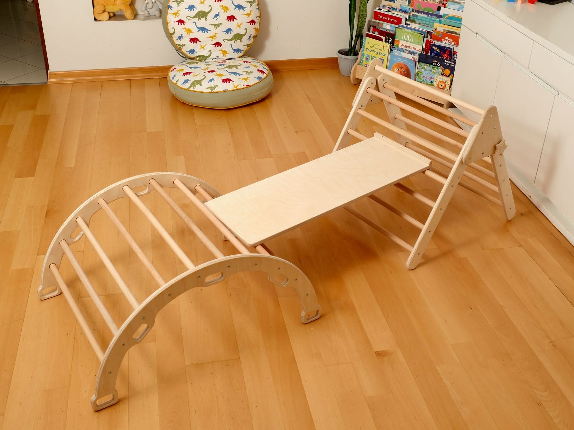 Montessori indoor playground set with climbing arch and triangle for toddlers on wooden floor.