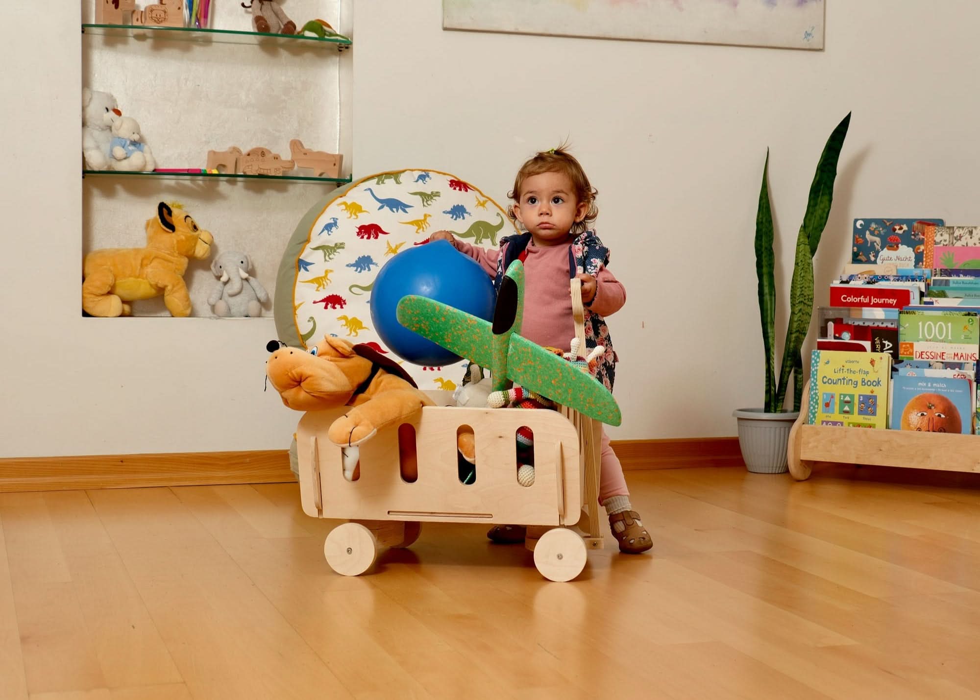 Kids playing with stuffed animals and toys in eco-friendly Montessori wooden toy storage organizer.